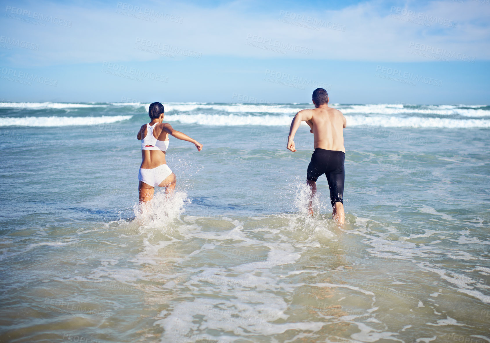 Buy stock photo A couple running at the beach
