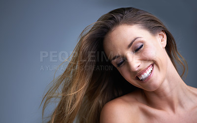 Buy stock photo Hair, beauty and happy woman in studio with cosmetics, shampoo or treatment results on grey background. Haircare, smile and model with growth, shine or texture satisfaction or clean scalp confidence