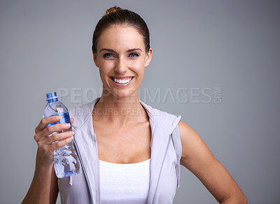 Buy stock photo Fitness, portrait and happy woman with water in studio for training, wellness or detox on grey background. Sports, bottle and face of female model with liquid hydration for body workout recovery