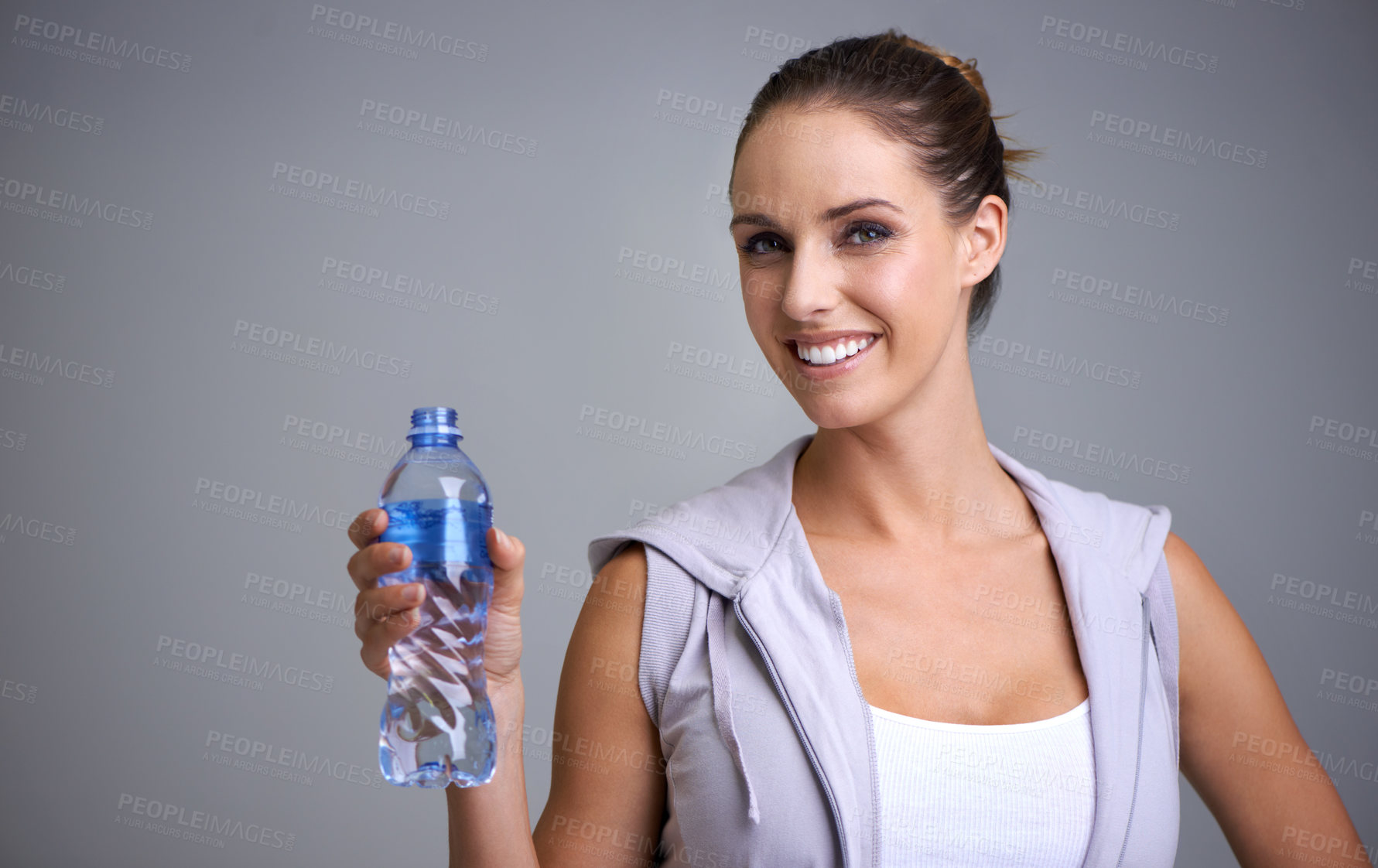 Buy stock photo Happy woman, portrait and water bottle in fitness for hydration on a gray studio background. Face of thirsty female person or athlete with smile and mineral drink for natural sustainability on mockup