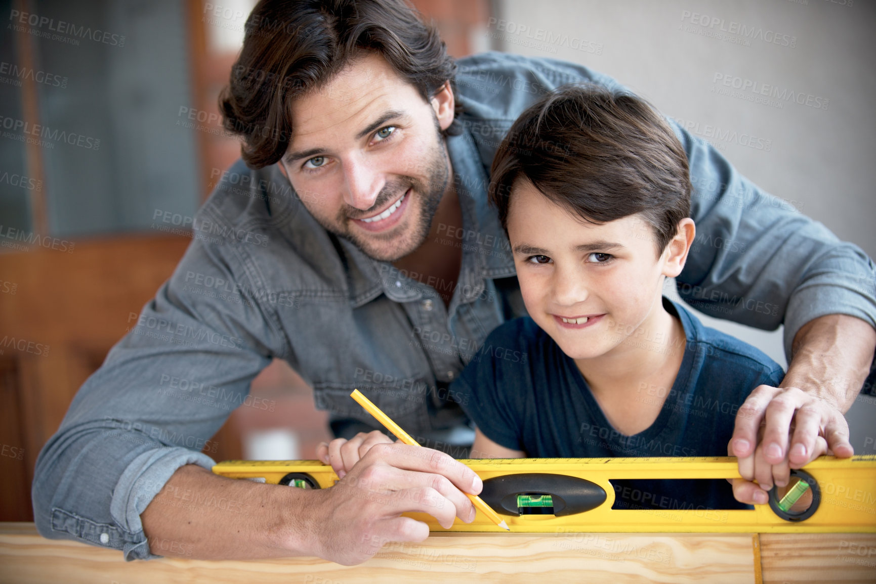 Buy stock photo Father, kid and woodwork at home for portrait, bonding and building with safety gear. Dad, son and carpenter for renovating, measuring and teaching moment for development of house with construction  