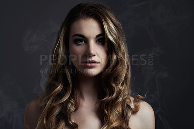 Buy stock photo A beautiful young woman posing in the studioStudio concept shot of a beautiful young woman with smoke coming off her