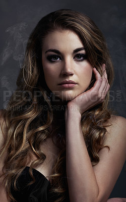 Buy stock photo Studio concept shot of a beautiful young woman with smoke coming off her