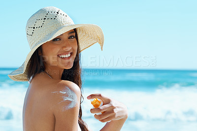 Buy stock photo Woman, portrait and beach with sunscreen on shoulder for skin, health and happy by waves for vacation. Girl, person and smile with hat, serum and sunblock for uv light, sunburn and safety in Naples