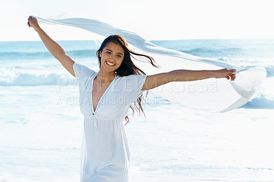 Buy stock photo Woman, ocean and portrait with fabric in wind with smile for freedom, adventure and relax in nature by waves. Girl, person and happy with cloth on holiday, vacation and outdoor by sea in Indonesia