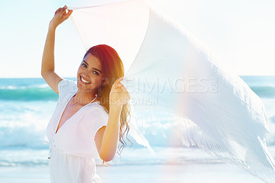 Buy stock photo Woman, beach and portrait with fabric in wind for freedom, adventure or relax with smile in nature by ocean. Girl, person and happy with sarong on holiday, vacation and waves in sunshine in Indonesia