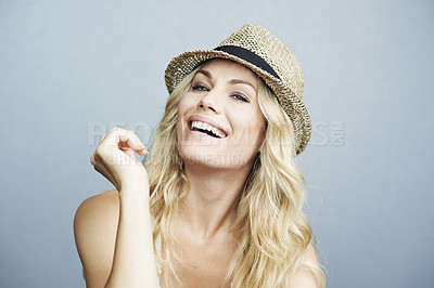 Buy stock photo Portrait, fashion and beauty with a model woman on a gray background in studio for trendy style or cosmetics. Face, smile and hat with a happy young female person excited for summer or spring