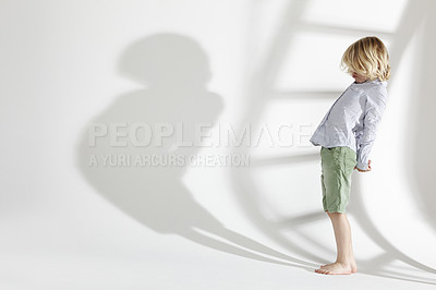 Buy stock photo Studio, child and shadow of a boy standing, growing and looking at ladder on a isolated and white background. Kid, future and goal of growth, development or silhouette of children or childhood 
