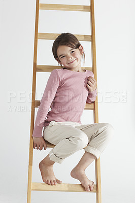 Buy stock photo Portrait, smile and child on ladder in studio isolated on a white background. Happy, kid and cute girl sitting, young and innocent with fashion, style or excited pose in casual clothes in Canada.