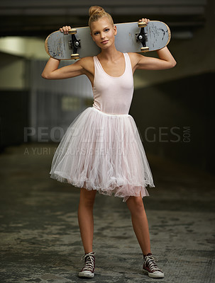 Buy stock photo A young ballerina holding a skateboard while wearing a tutu and sneakers