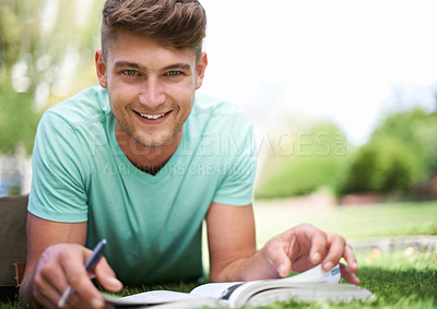 Buy stock photo Man, studying and books on grass for portrait, smile and pride for learning, development and reading. Person, university student and happy with notes, information and knowledge for college education