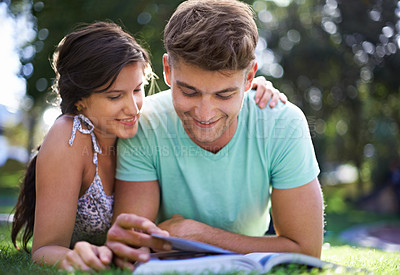 Buy stock photo Happy, grass and couple with books for reading, learning and studying together outdoors at college. University, education and man and woman with textbook in park for bonding, relax and rest on campus