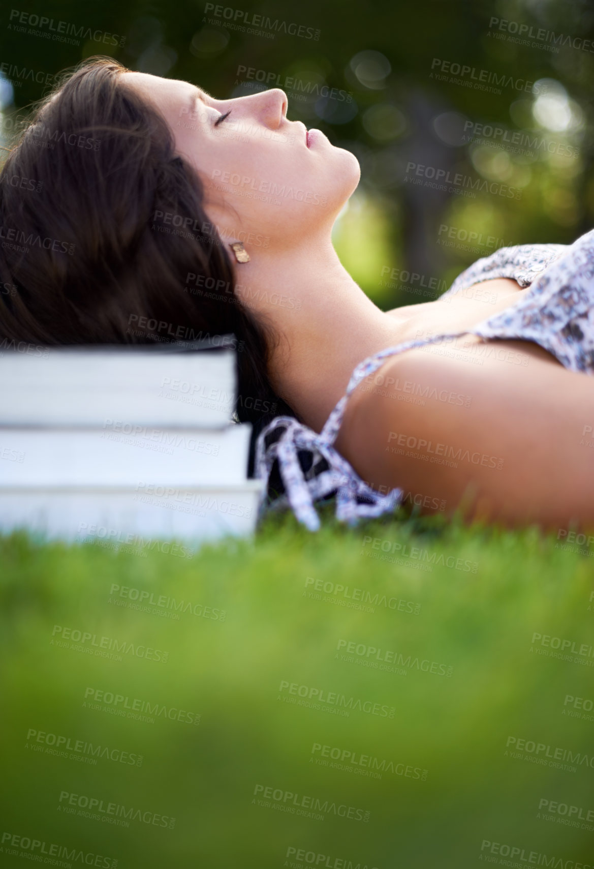 Buy stock photo Books, grass and woman on campus relax, calm and resting for studying, class and learning. Education, university and person outdoors for wellness, fresh air and peace with textbooks for knowledge