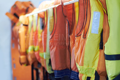 Buy stock photo Shot of life vests on a hanger