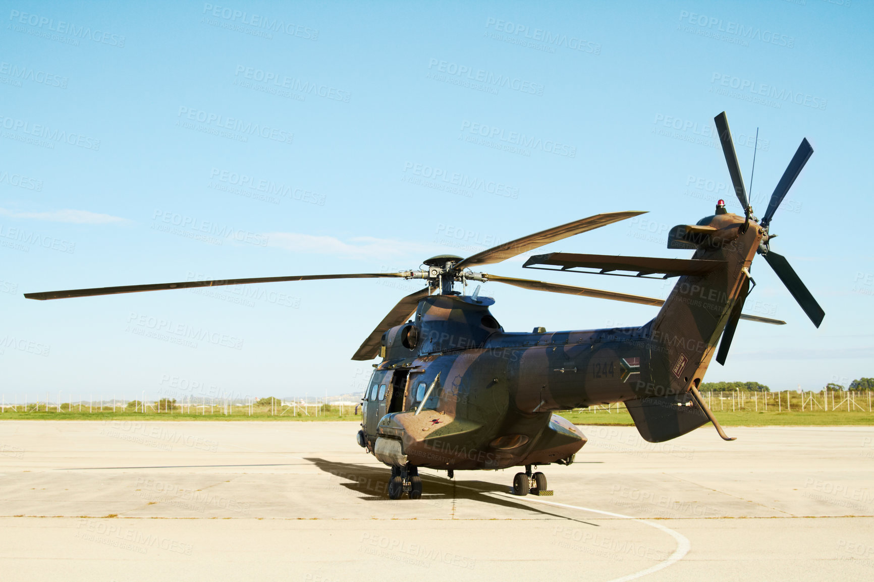 Buy stock photo A military helicopter standing on a launchpad