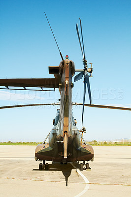 Buy stock photo Military, camouflage and a helicopter landing at a special forces base outdoor for army transportation. Aircraft, vehicle or air transport with a chopper ready for war, combat or defense outside