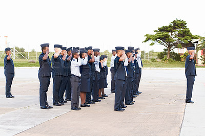 Buy stock photo Shot of a group of armed forces personnel saluting