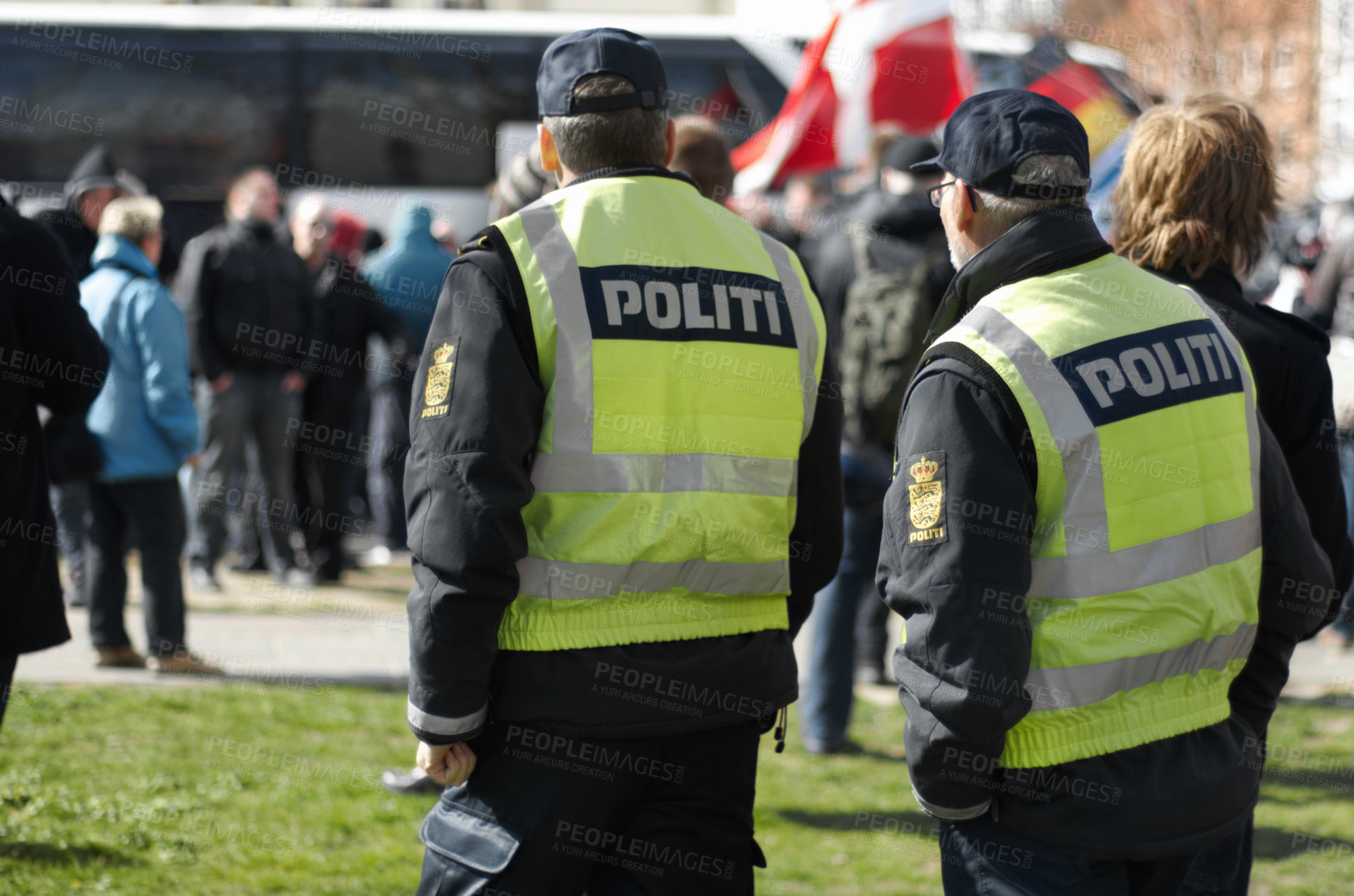 Buy stock photo Law enforcement, safety and crowd control with police officer in city for peace, security or authority. Emergency services, justice and guard with person in Denmark street for rally, order and arrest