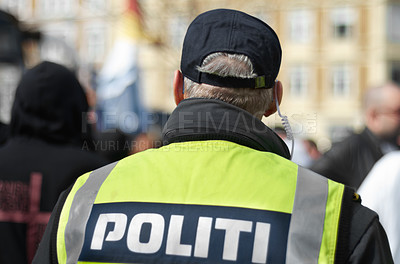 Buy stock photo Law enforcement, protection and security with police officer in crowd for peace, safety and authority. Emergency services, justice and guard with back of person in city for rally, order and arrest