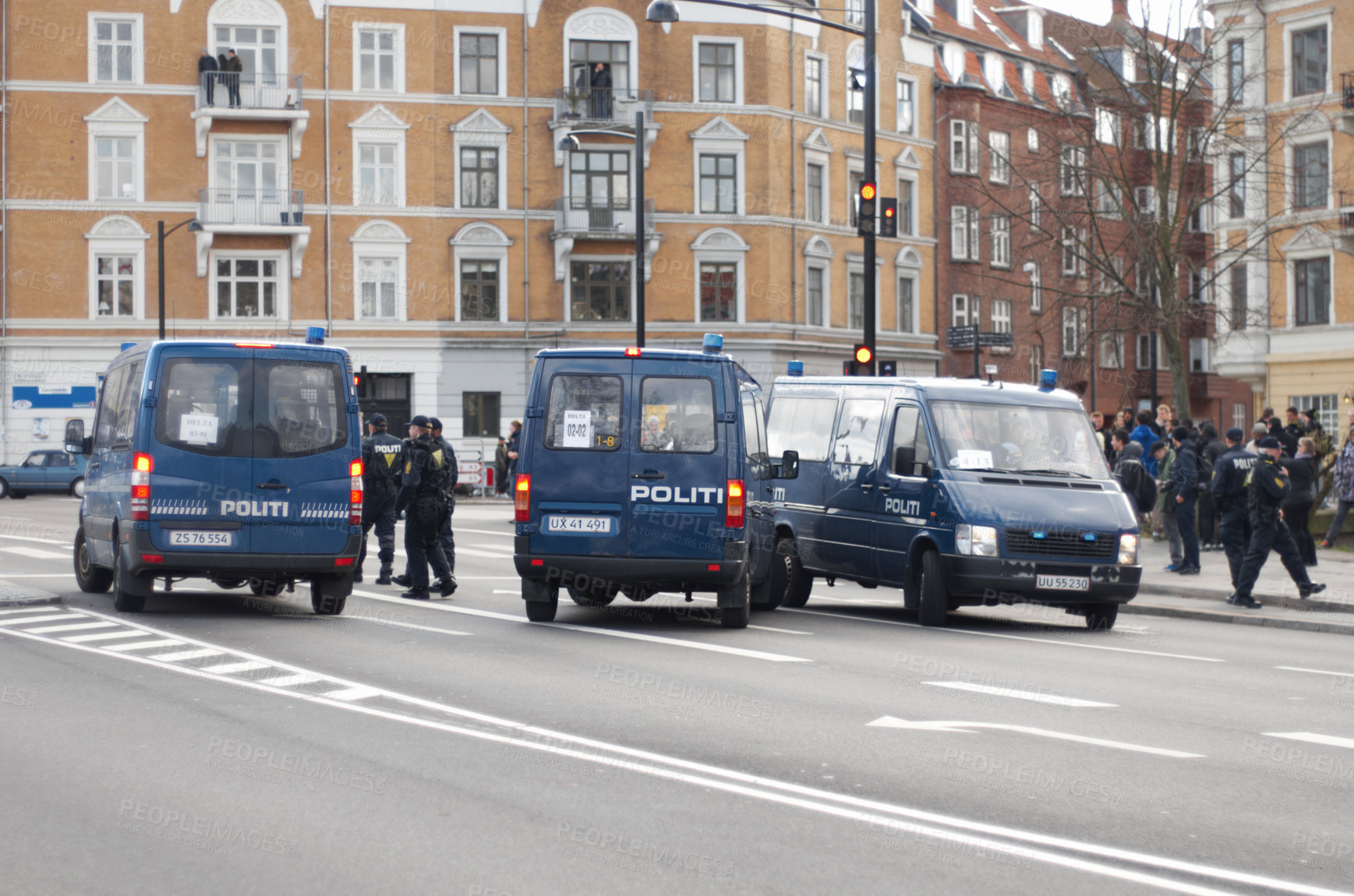 Buy stock photo Police, van and street with crowd, safety or protection service for public with justice in city. Vehicle, law enforcement and outdoor for danger, arrest and transportation on urban road in Copenhagen
