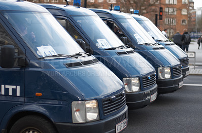 Buy stock photo Street, city and row of police vans for a public service and safety during a protest or march. Security, crime and law enforcement transport in a line as a barrier in urban town strike for protection