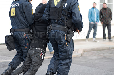 Buy stock photo Policemen apprehending a susect