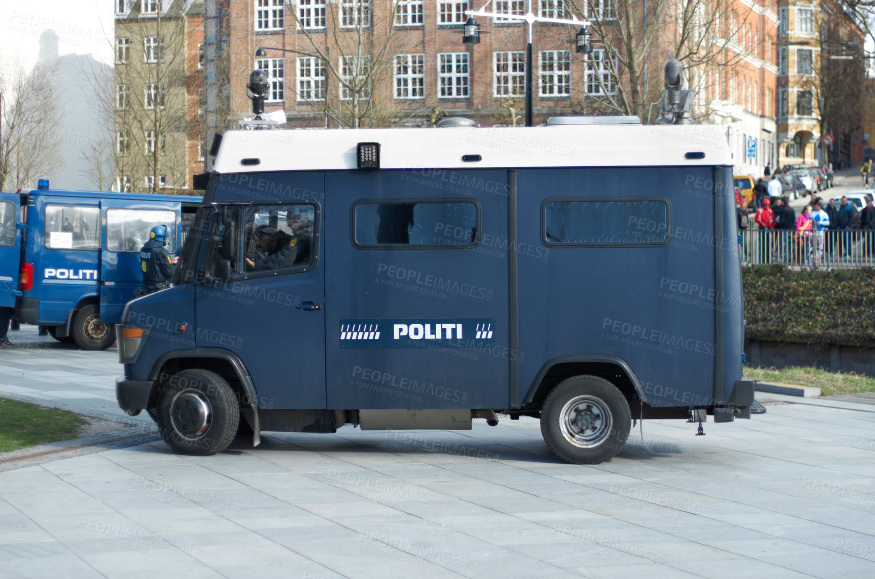 Buy stock photo Police, van and city for transport, safety or protection service for public justice in in street. Vehicle, law enforcement and outdoor for danger, arrest and armored truck on urban road in Copenhagen