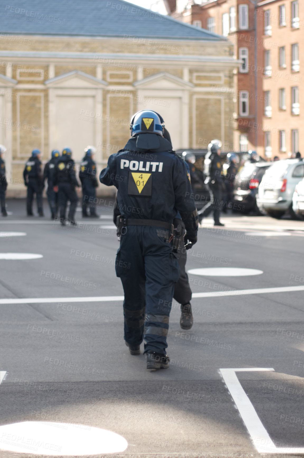Buy stock photo Security, authority and back of police officer in the city working to patrol a protest or march. Law enforcement, public service and safety guard in uniform for protection in an urban town street.