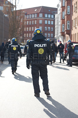 Buy stock photo Security, justice and back of policeman in the city working to patrol protest or march. Law enforcement, public service and safety guard or officer in uniform for protection in town street in Denmark