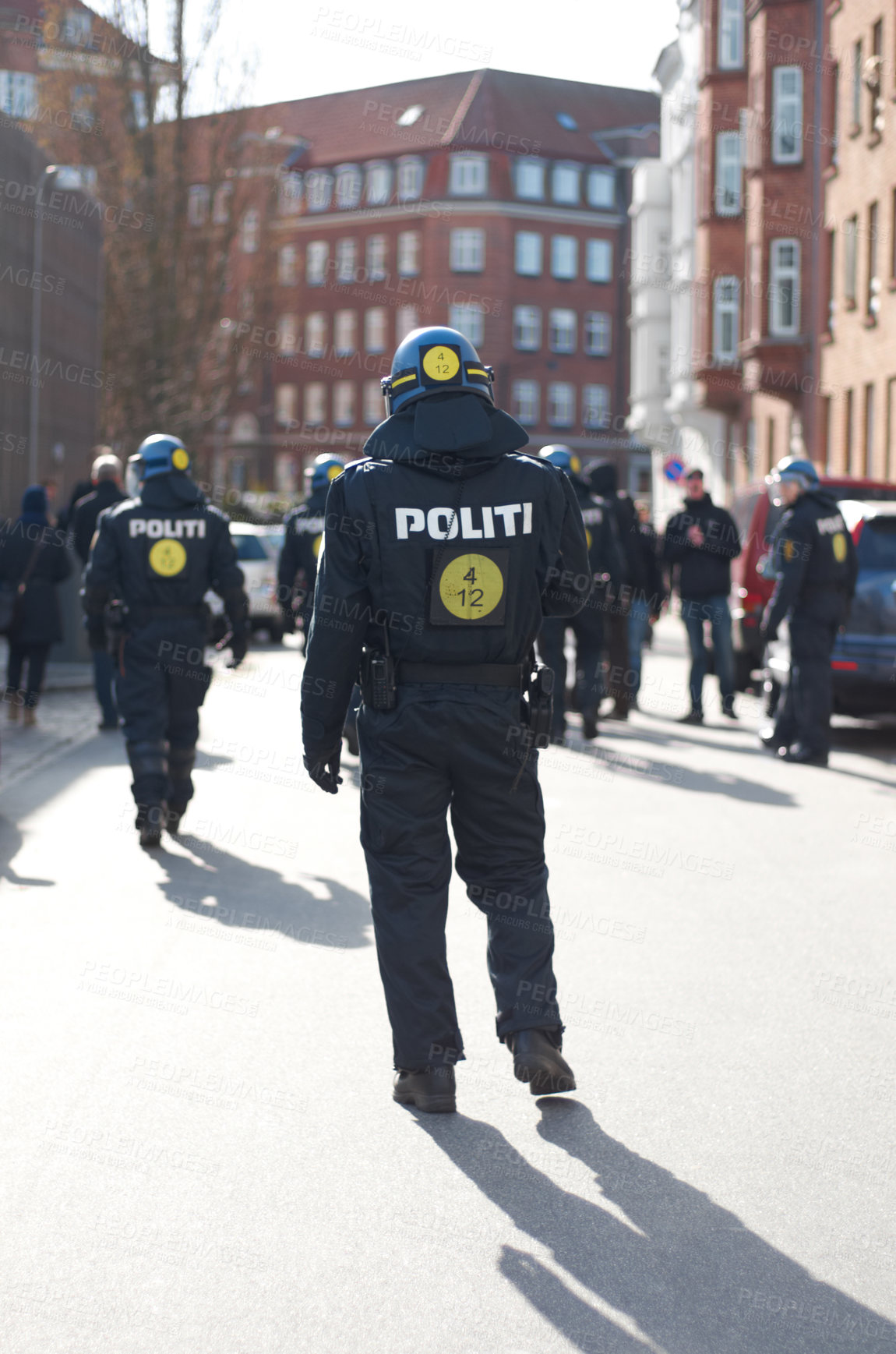 Buy stock photo Security, justice and back of policeman in the city working to patrol protest or march. Law enforcement, public service and safety guard or officer in uniform for protection in town street in Denmark