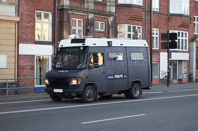 Buy stock photo Armored van, police and transport in street for safety, justice and patrol for protection in city. Vehicle, urban road and driving for public service to stop crime in metro by buildings in Copenhagen