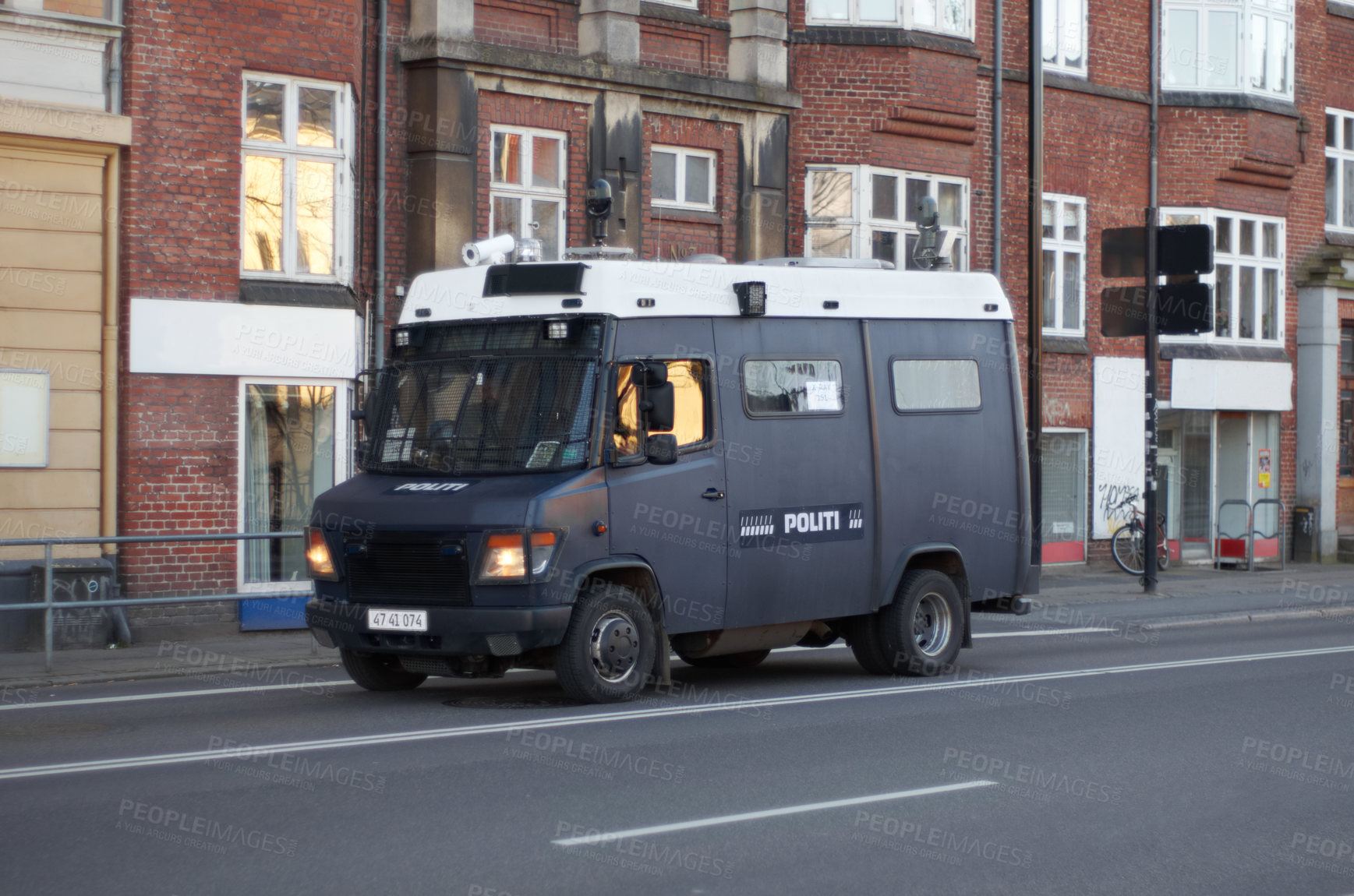 Buy stock photo Armored van, police and transport in street for safety, justice and patrol for protection in city. Vehicle, urban road and driving for public service to stop crime in metro by buildings in Copenhagen