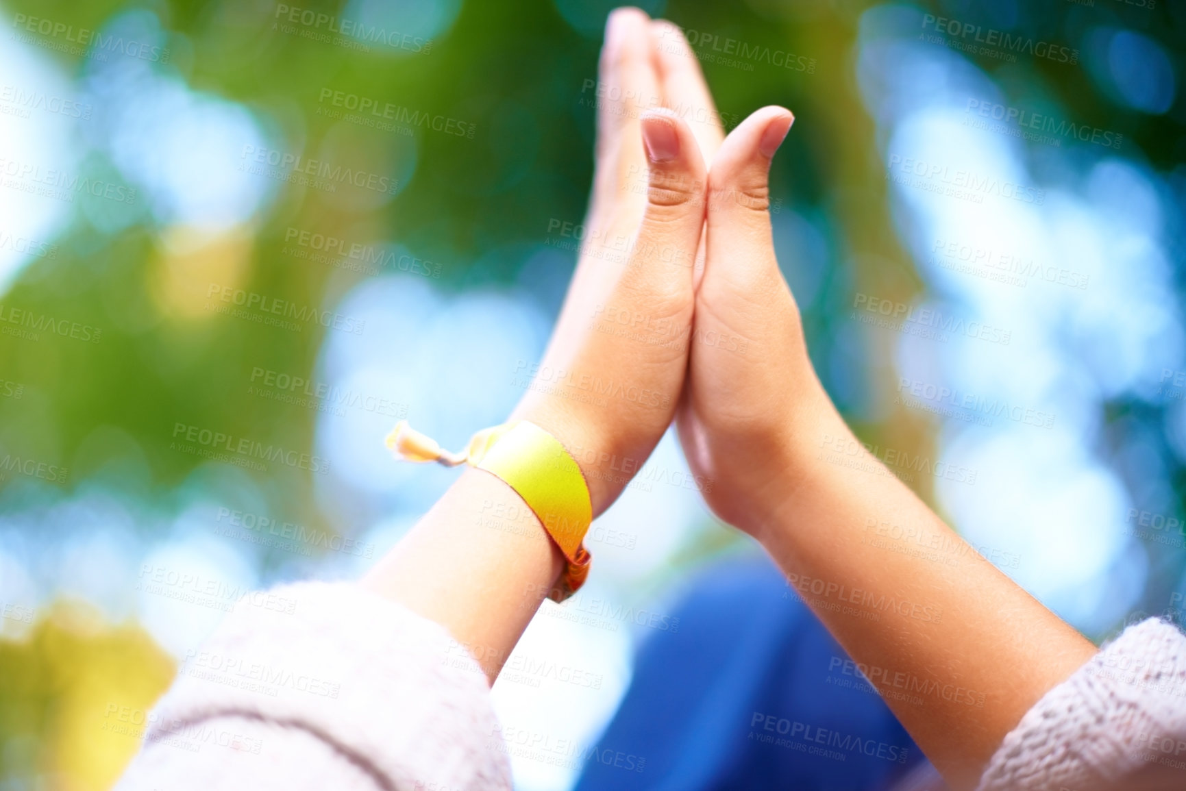 Buy stock photo Outdoor, closeup and people with high five, nature and agreement with bokeh background or fresh air. Fun, closeup or friends with hand gesture or support with party or event with motivation or ribbon
