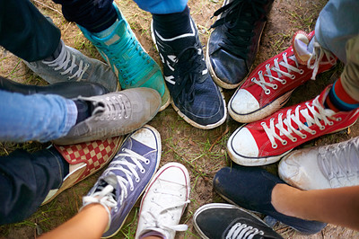 Buy stock photo A high-angle view of a group of people wearing sneakers and standing in a circle