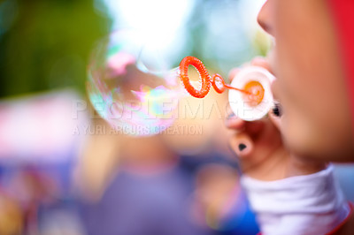 Buy stock photo Closeup, blowing bubbles and outdoor with woman, summer and weekend break with event. Party, person and girl in a park and happy with  soap toy and bokeh background with nature, rainbow and festival 
