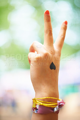 Buy stock photo A young woman with a heart tattoo on her hand