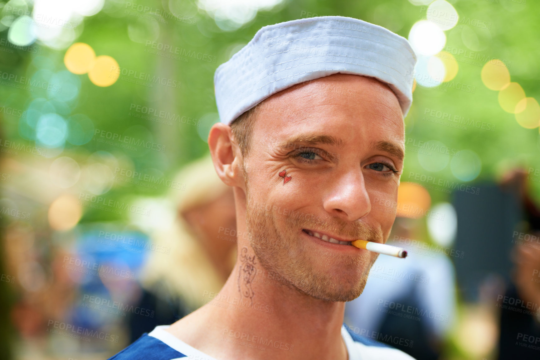 Buy stock photo Portrait, smile and man with a cigarette, music festival and sailor outfit with fun and costume. Face, person and guy with tobacco, outdoor or nicotine with concert or happy with culture or bad habit