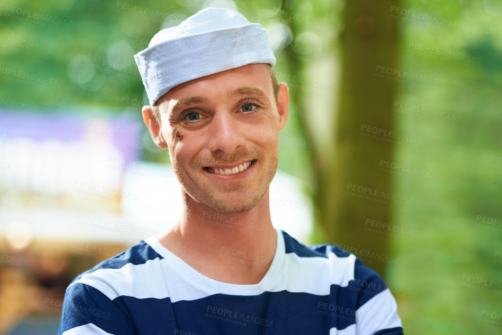 Buy stock photo Portrait, music festival and outdoor with man, costume and happiness with weekend break and holiday. Face, person or cheerful guy with Halloween clothes and concert with sailor outfit or summer party