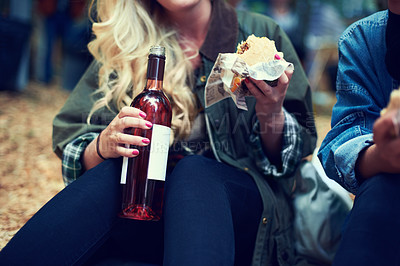 Buy stock photo Snack, woman and music festival with friends, beer and happiness with joy and bonding together. Alcohol, outdoor and girl with fast food or takeaway with summer break or concert with culture or event