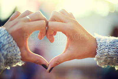 Buy stock photo A young woman's hands making a heart shape