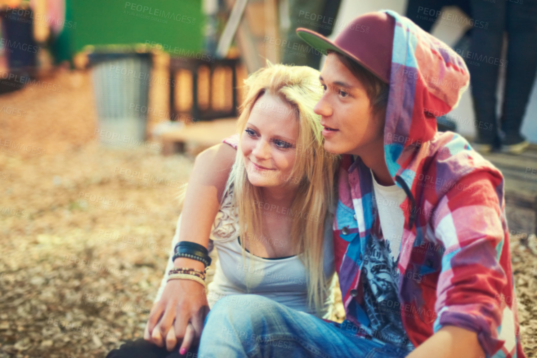 Buy stock photo Couple, teenager and music at concert, festival and performance while bonding in Australia. Trendy, teen and youth on date as sitting outside with smile, happiness and love at punk, show and live gig