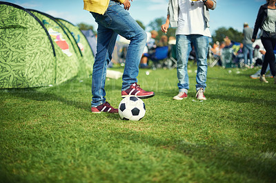 Buy stock photo Man, feet and playing with soccer ball outside of his tent group of colourful camping. Row of marquees placed on ground at musical concert, entertainment event and carnival celebration sporty party 