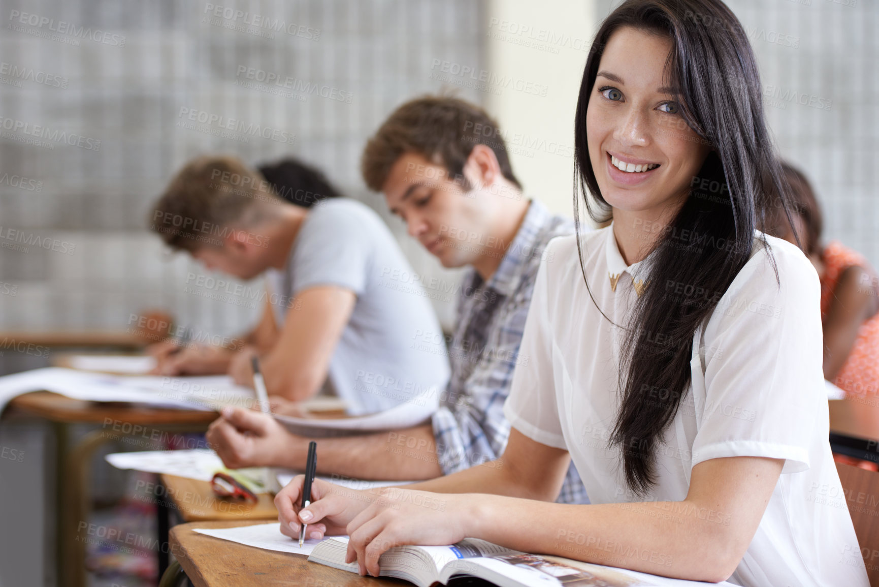 Buy stock photo Shot of an attractive young college student studying in class