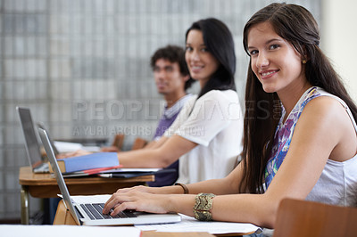 Buy stock photo University, laptop and portrait of woman in classroom typing with smile, learning and future opportunity. Education, knowledge and growth for group of students in college lecture studying for exam.