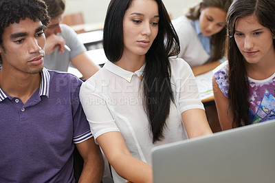 Buy stock photo Shot of a group of university students working on laptops in class