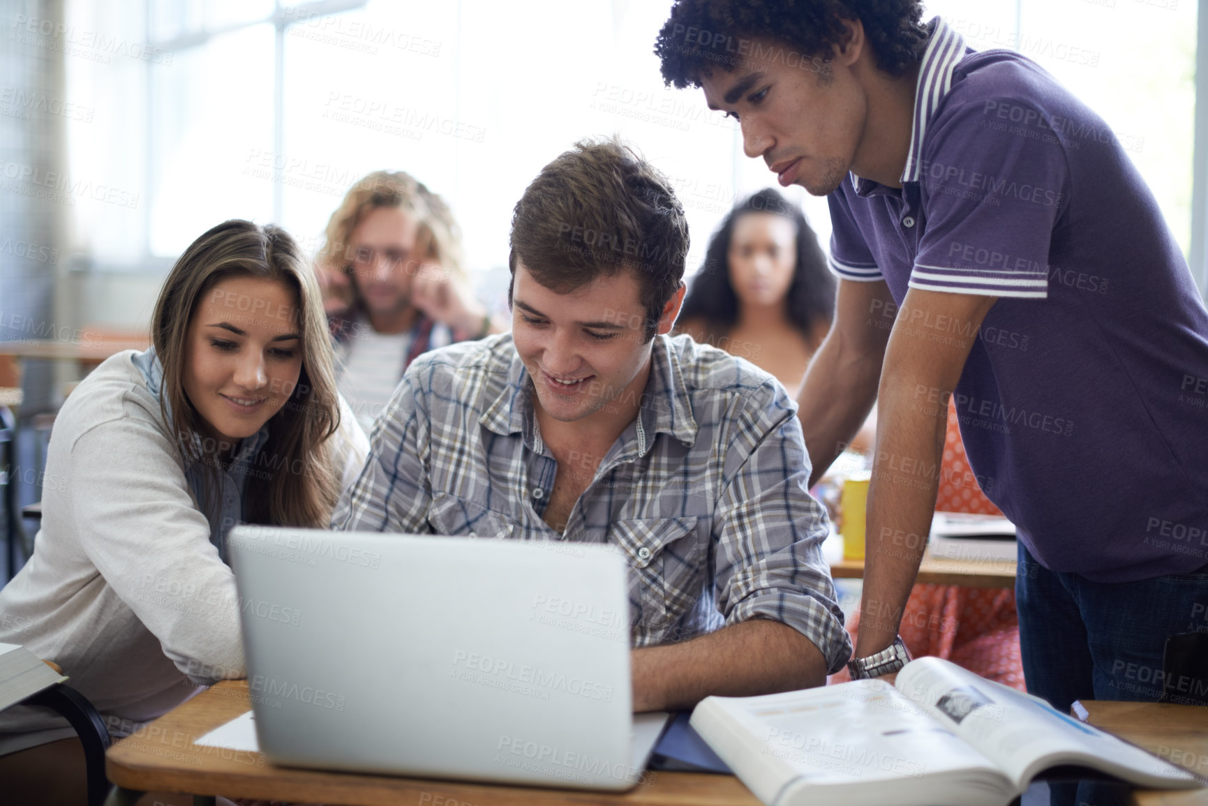 Buy stock photo Shot of a group of university students working on laptops in class