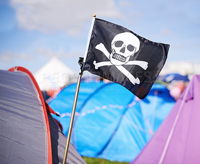 Buy stock photo Pirate flag, tent and camping at festival outdoor in summer for party, event or celebration closeup. Skull, crossbones or jolly roger in nature for performance, entertainment or adventure with crowd