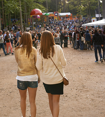 Buy stock photo Event, festival or party with woman friends walking outdoor on ground for concert with group of people. Nature, forest or woods with young girls on sand together in audience or crowd from back