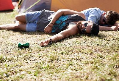 Buy stock photo Drunk, sleeping and men on camping ground at a music festival with alcohol. Field, drinking and lawn with a tent and youth on grass with people and man camper at concert outdoor with cans