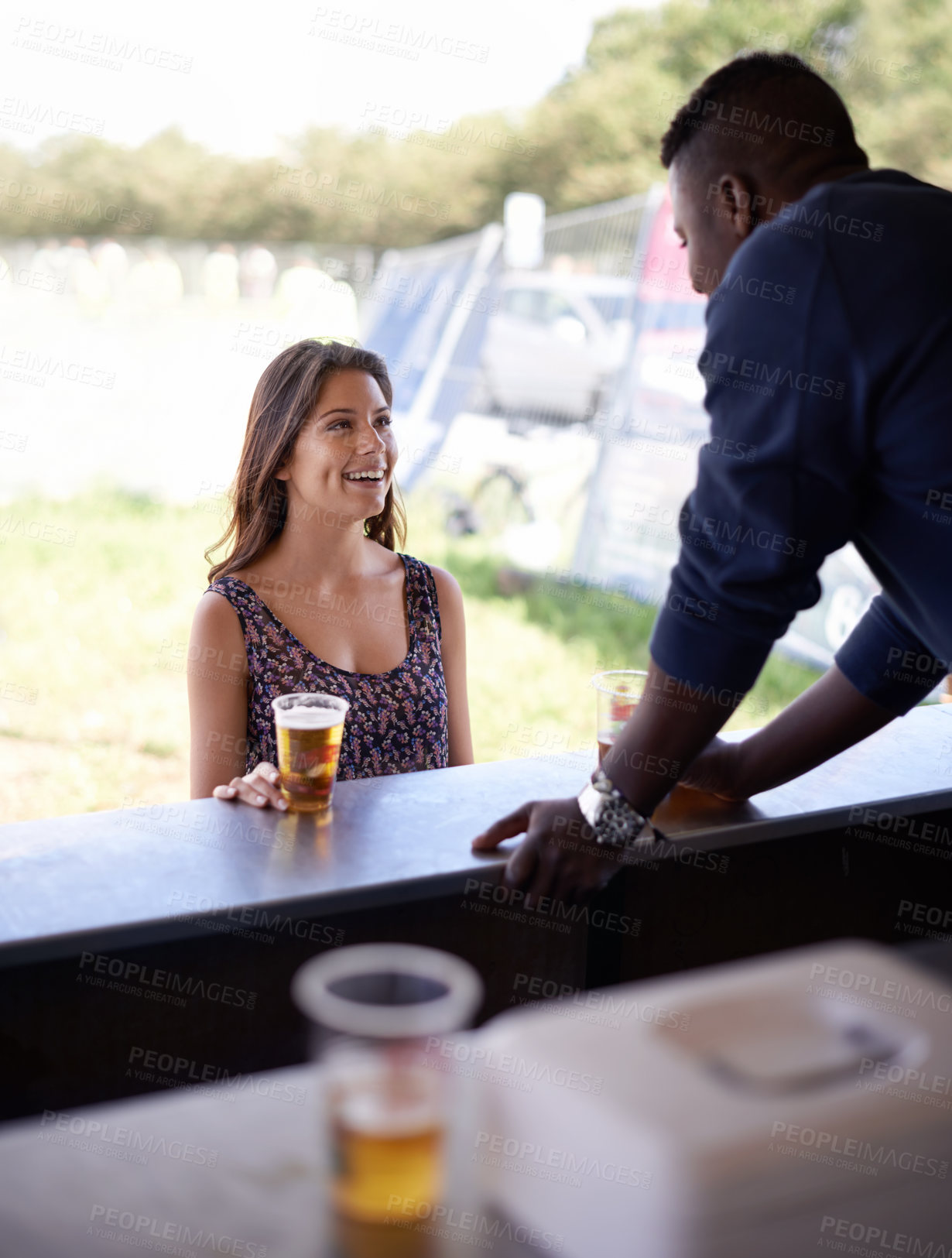 Buy stock photo Smile, beer and woman bar customer outdoor at event, festival or party for summer celebration. Drink, alcohol and happy young person at counter to purchase beverage from beverage at social gathering